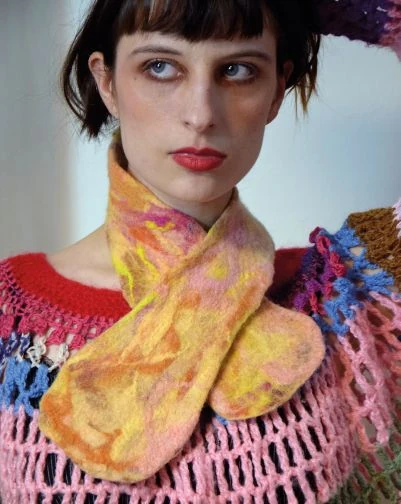 Portrait of artist Fanny Flaesa wearing a colorful textile garment